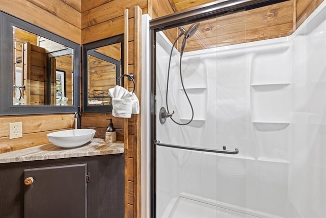 bathroom with wood walls, vanity, and an enclosed shower