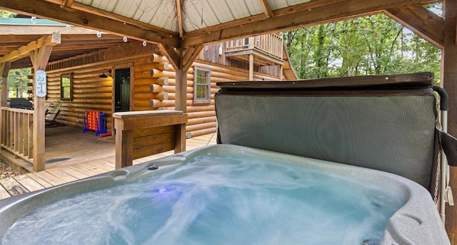 view of patio with a wooden deck and a hot tub