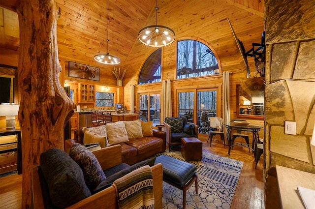 living room featuring wood walls, hardwood / wood-style floors, high vaulted ceiling, and wooden ceiling