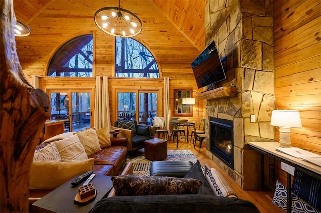 living room with hardwood / wood-style floors, wooden ceiling, a fireplace, and high vaulted ceiling