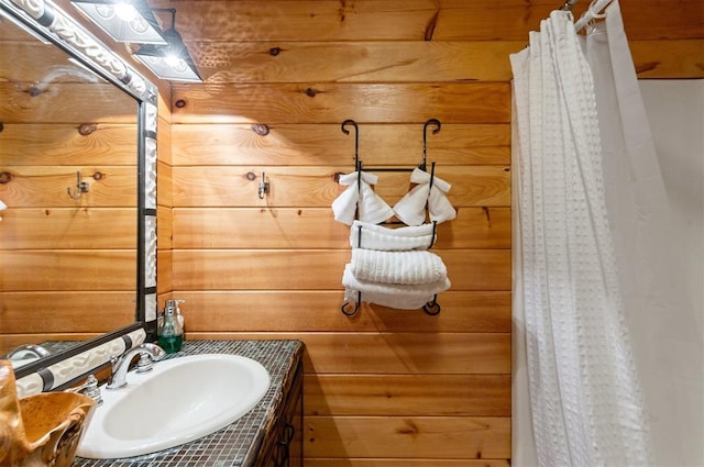 bathroom with wood walls and vanity