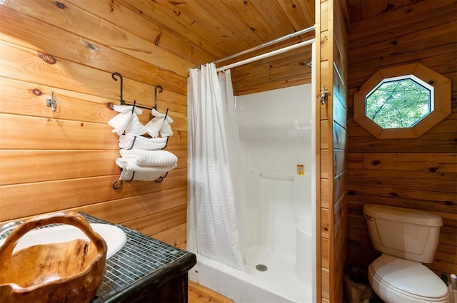 bathroom featuring wood walls, curtained shower, and toilet