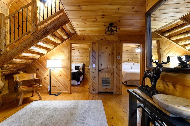 bonus room with wooden walls, wooden ceiling, vaulted ceiling, and light wood-type flooring