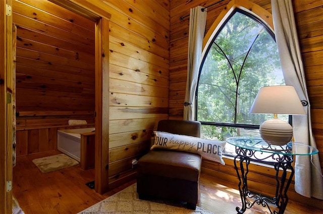 living area featuring wooden walls and wood-type flooring