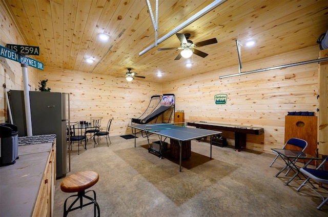 game room featuring ceiling fan, wooden ceiling, and wood walls