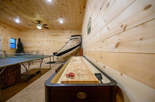 playroom featuring wood ceiling, wood walls, ceiling fan, and concrete flooring