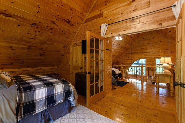 bedroom featuring wood ceiling, wooden walls, wood-type flooring, and vaulted ceiling