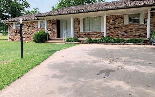 ranch-style home with a front yard and a porch