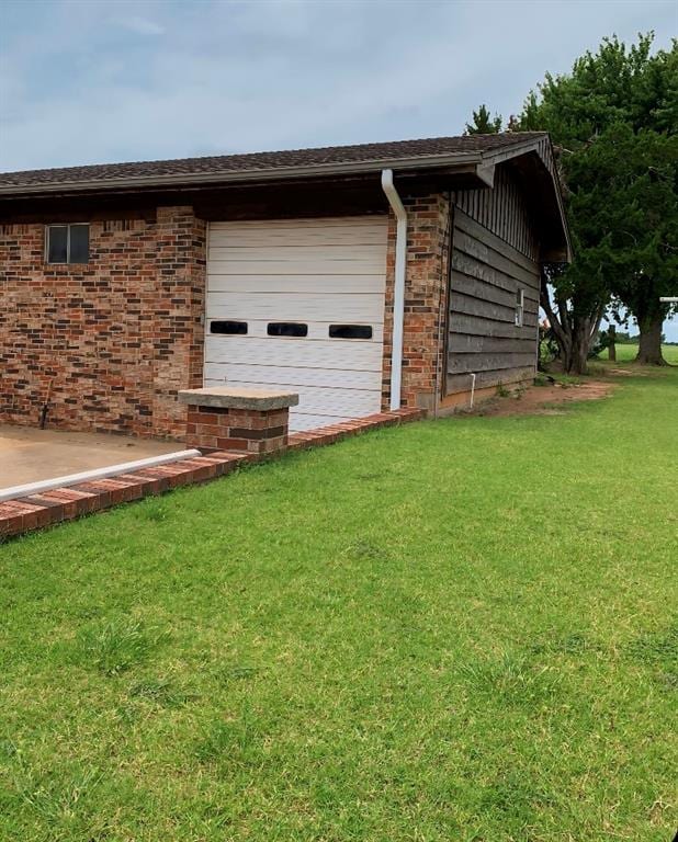 view of property exterior featuring a lawn and a garage