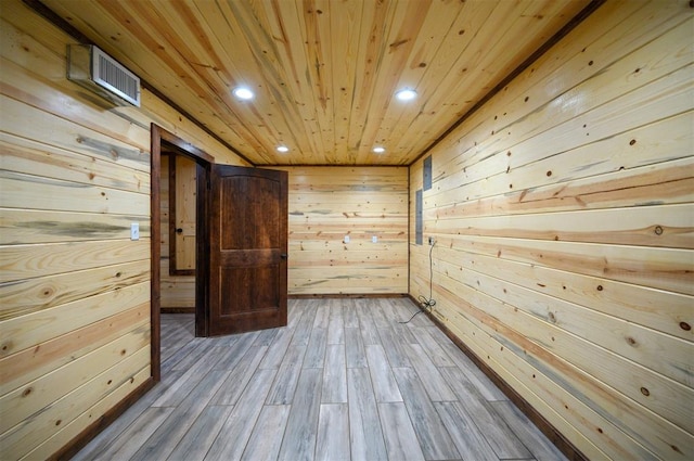 empty room with hardwood / wood-style flooring, wooden walls, and wooden ceiling