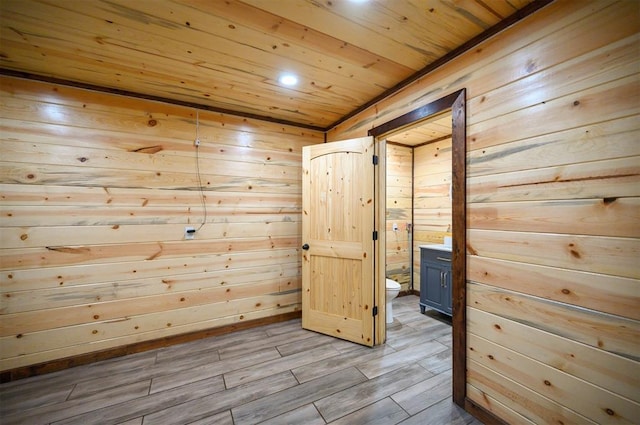 interior space featuring light hardwood / wood-style floors and wood walls