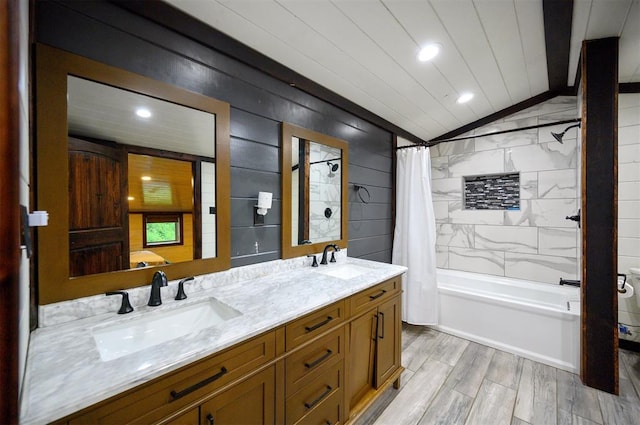 bathroom with vanity, lofted ceiling, hardwood / wood-style floors, and shower / bath combo with shower curtain