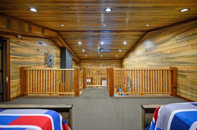 bedroom with carpet floors, wooden ceiling, wood walls, and vaulted ceiling