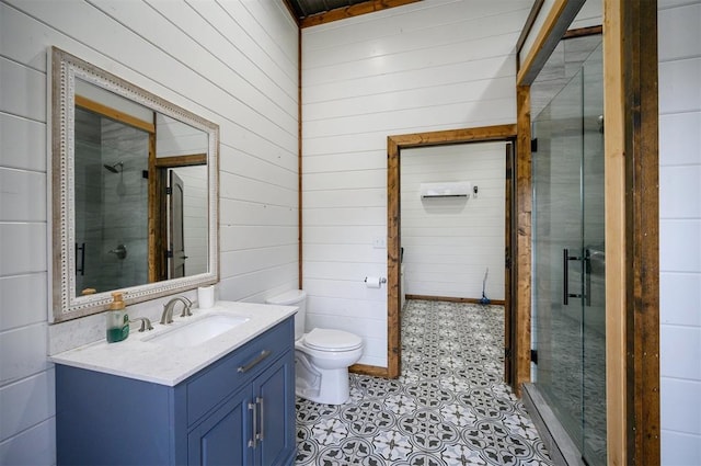 bathroom featuring vanity, an enclosed shower, wooden walls, and toilet