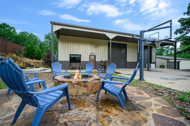 view of patio with a hot tub and an outdoor fire pit