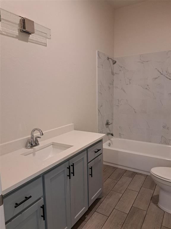 full bathroom featuring vanity, toilet, and tiled shower / bath