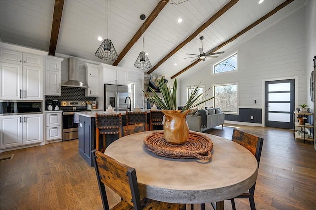 dining space featuring high vaulted ceiling, dark hardwood / wood-style flooring, and beamed ceiling