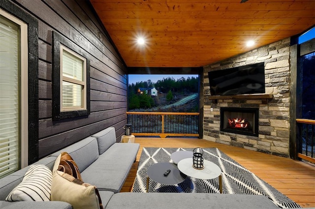 exterior space with vaulted ceiling, wood-type flooring, wooden ceiling, and an outdoor stone fireplace