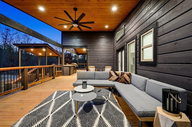 wooden deck featuring an outdoor hangout area and ceiling fan