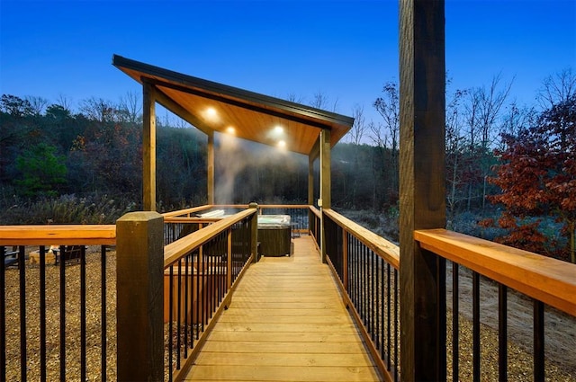 deck at dusk with a jacuzzi