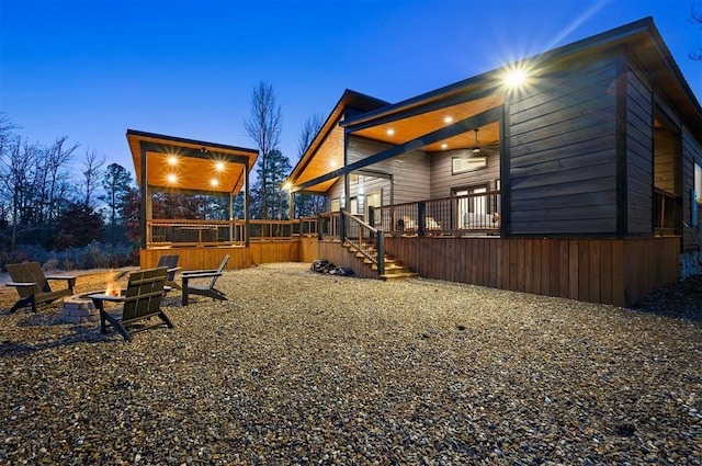 exterior space featuring a deck and an outdoor fire pit