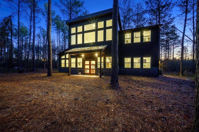 back house at dusk featuring french doors