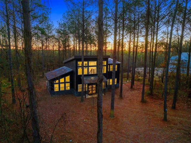 view of back house at dusk