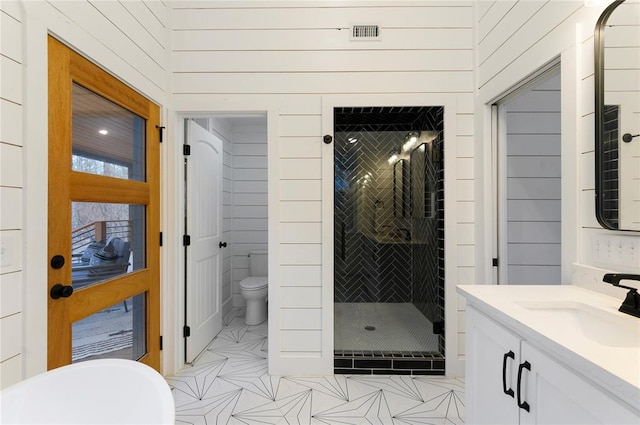 full bathroom with tile patterned floors, vanity, toilet, and independent shower and bath