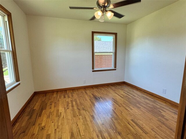 unfurnished room with ceiling fan and hardwood / wood-style floors