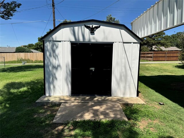 view of outbuilding with a yard