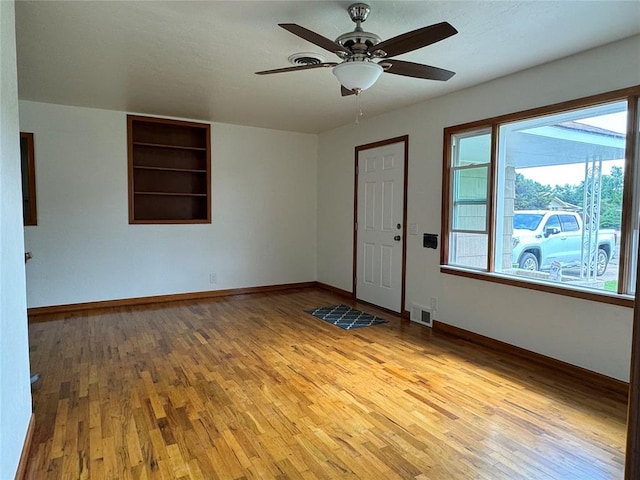 spare room featuring ceiling fan and light wood-type flooring