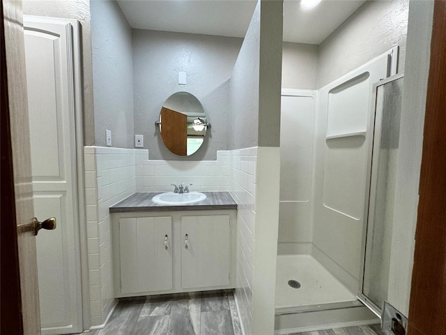 bathroom featuring a shower and vanity