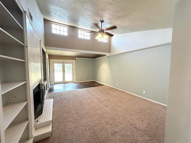 unfurnished living room featuring carpet flooring, french doors, a textured ceiling, and ceiling fan