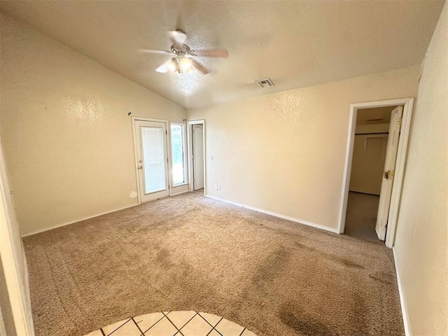 unfurnished room featuring ceiling fan, light colored carpet, and vaulted ceiling