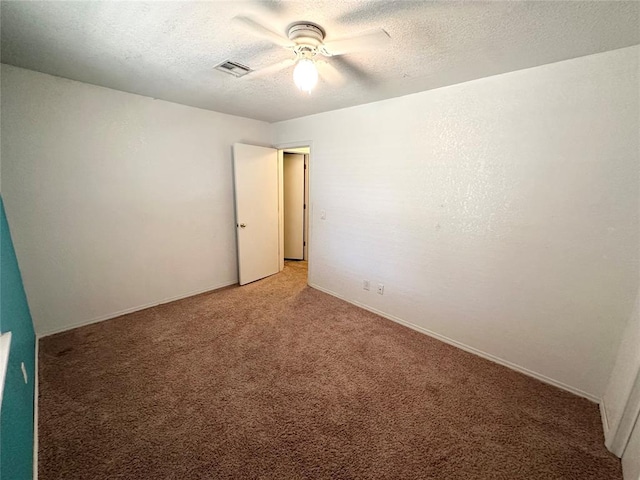 empty room featuring carpet, a textured ceiling, and ceiling fan