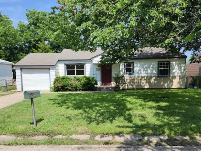 single story home featuring a garage and a front lawn