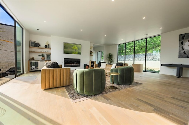 living room with floor to ceiling windows and light wood-type flooring