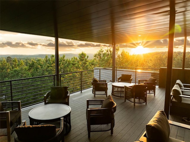 deck at dusk featuring an outdoor hangout area