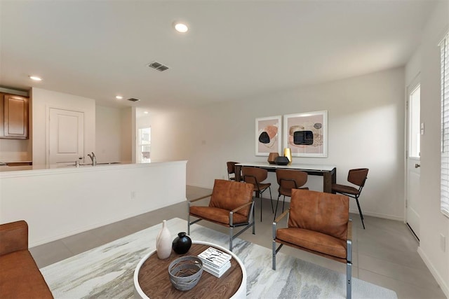 sitting room featuring sink and light tile patterned floors