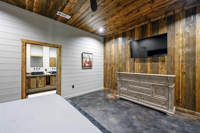 bedroom with ensuite bath, wooden walls, and wooden ceiling