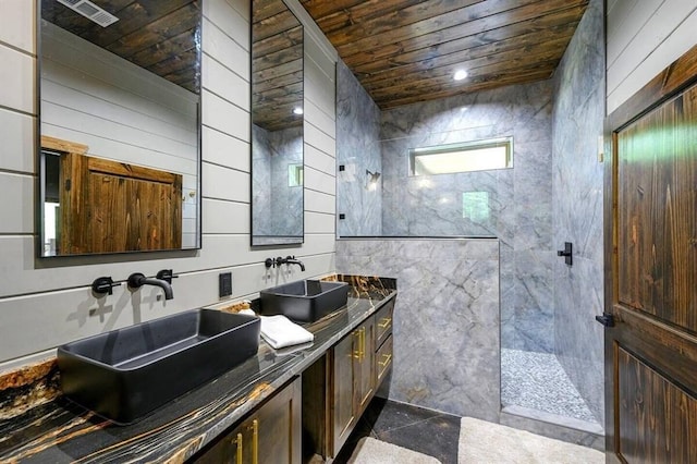 bathroom featuring tile walls, vanity, wood ceiling, and a shower