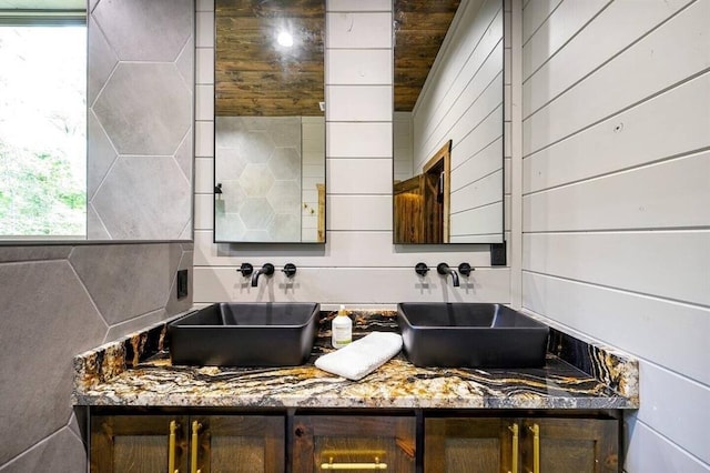 bathroom featuring wooden ceiling, vanity, and wood walls