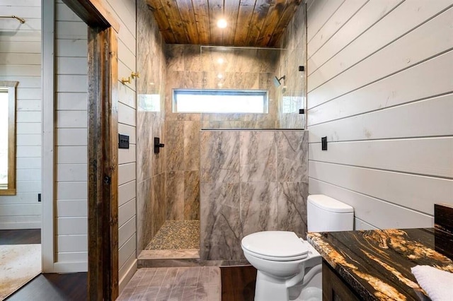 bathroom with wood ceiling, hardwood / wood-style floors, a tile shower, toilet, and wood walls