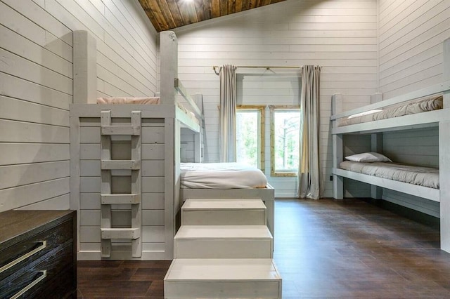 unfurnished bedroom featuring wood ceiling, lofted ceiling, and wooden walls