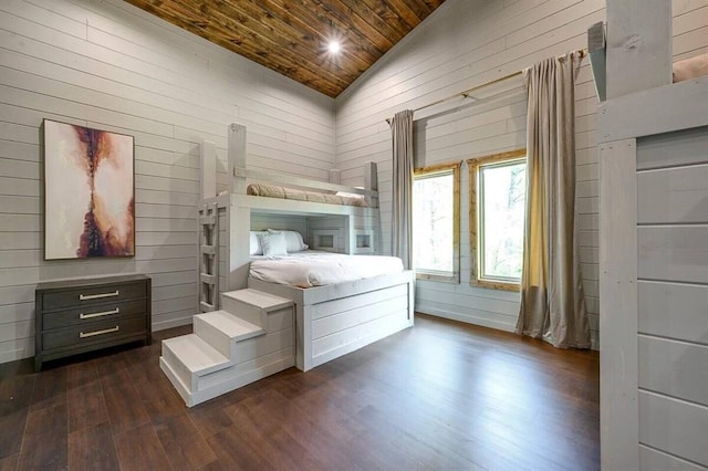 unfurnished bedroom with vaulted ceiling, dark hardwood / wood-style floors, wooden ceiling, and wooden walls