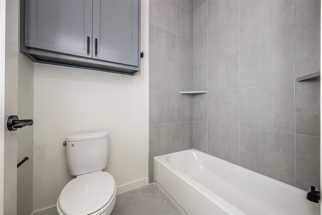 bathroom with tile patterned flooring, shower / bath combination, and toilet