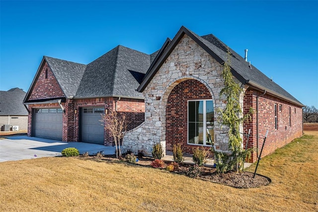 view of front of house with a garage and a front lawn