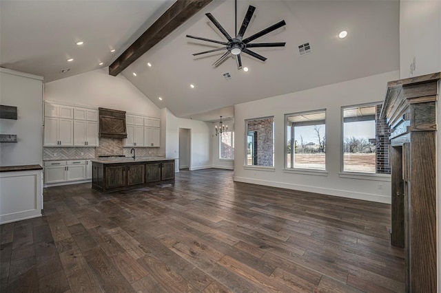 kitchen with a center island with sink, plenty of natural light, white cabinetry, and dark wood-type flooring