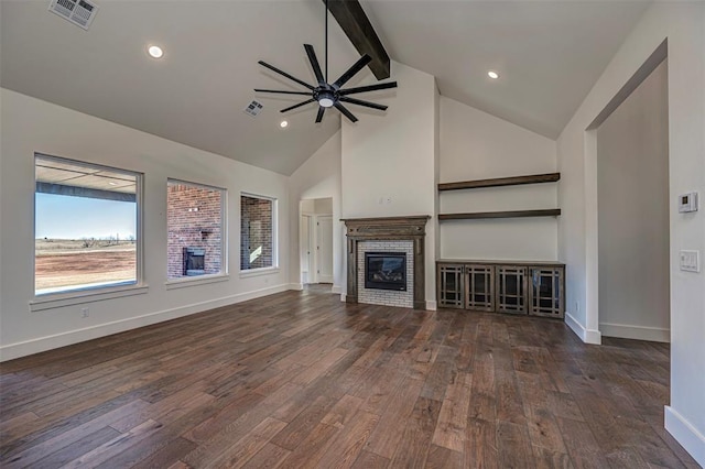 unfurnished living room with ceiling fan, dark wood-type flooring, beam ceiling, high vaulted ceiling, and a fireplace