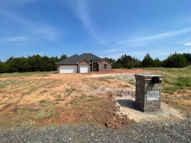 view of front of property with a rural view and a garage